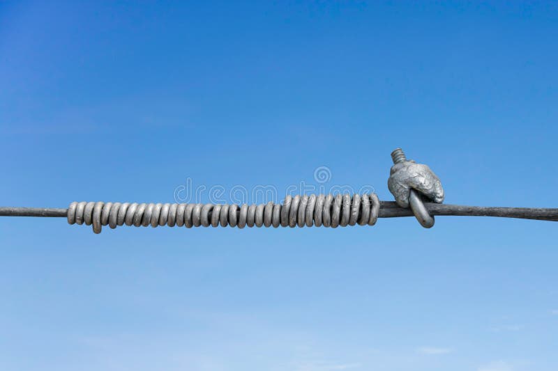 Metal line fastening. Of two cables with background of blue sky royalty free stock image