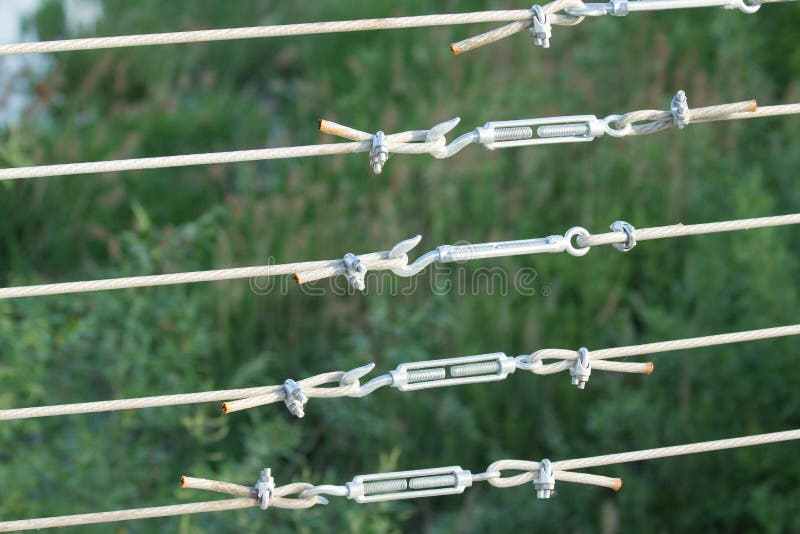 Metal turnbuckles fastening of hawser with steel rod. Closeup macro stock photos