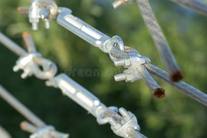 Metal turnbuckles fastening of hawser with steel rod. Closeup macro, perspective view royalty free stock image