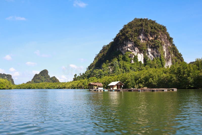 Mini house and stone mountain. In the mangrove swamp royalty free stock photo