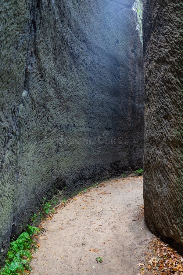 Narrow passage through stone walls stock photo
