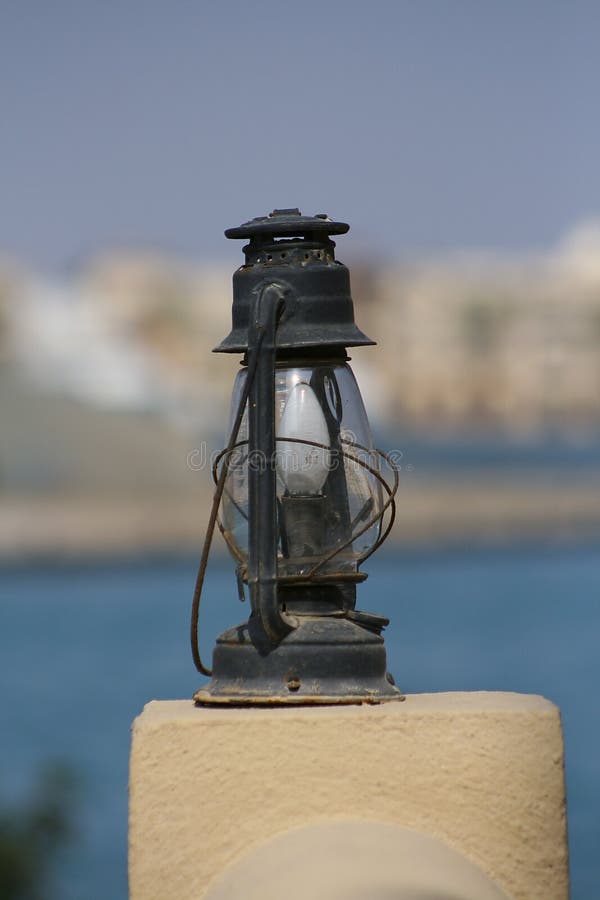 Old decorative oil lamp mounted on a stone plinth. Old decorative oil lamp converted for use with electricity mounted on a stone plinth royalty free stock images