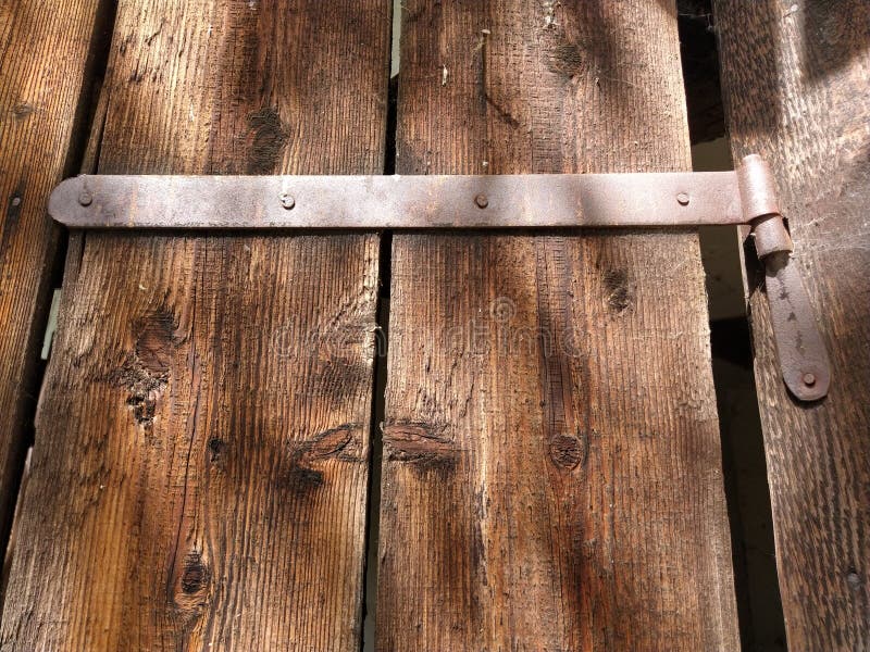 Old metal fastening to wooden doors or gates, rustic constructions.  royalty free stock photography