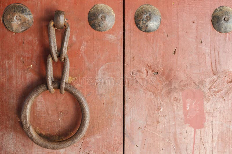 Old metal ring handle on red wooden door stock photo