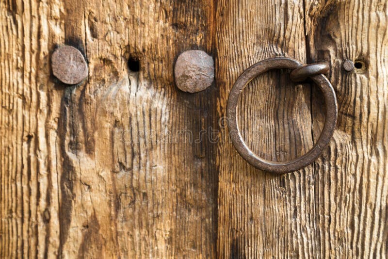 Old rustic wooden door with a ring handle stock photography