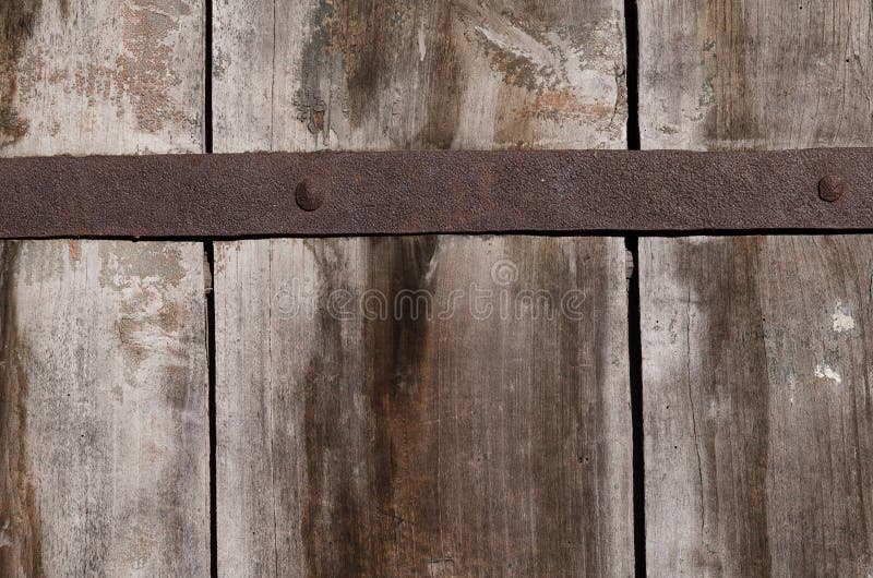 Old rusty metal fastening on thick wooden boards. Old rusty metal fastening on large, thick wooden boards, texture, horizontal colored photo royalty free stock photos