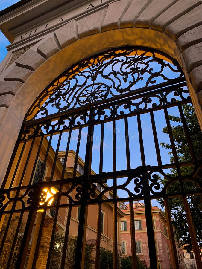 Old stone and wrought iron doorways of Italian roman villa at dusk in Rome, Italy. Beautiful old stone and wrought iron doorways of Italian roman villa at dusk royalty free stock photo Old stone and wrought iron doorways of Italian roman villa at dusk in Rome, Italy. Beautiful old stone and wrought iron doorways of Italian roman villa at dusk royalty free stock photo