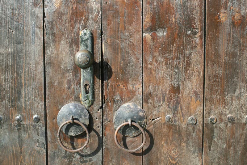 Old weathered wooden door with iron door handle on a traditional bulgarian house royalty free stock image