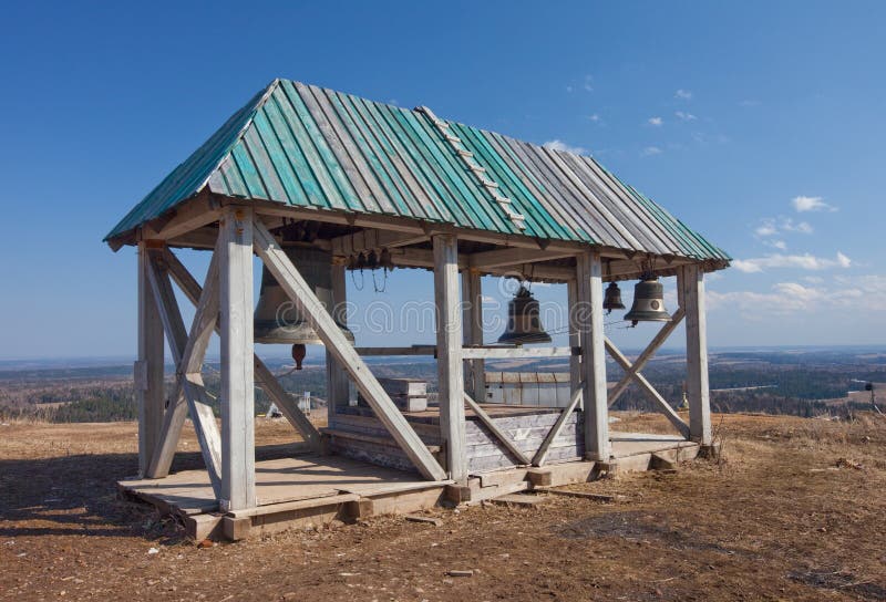 Old wooden belltower. Russia. White mountain stock photo