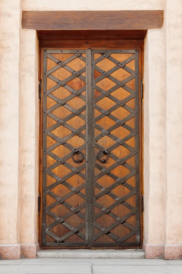Old Wooden Door with Circle Iron Door Handle Knocker royalty free stock images