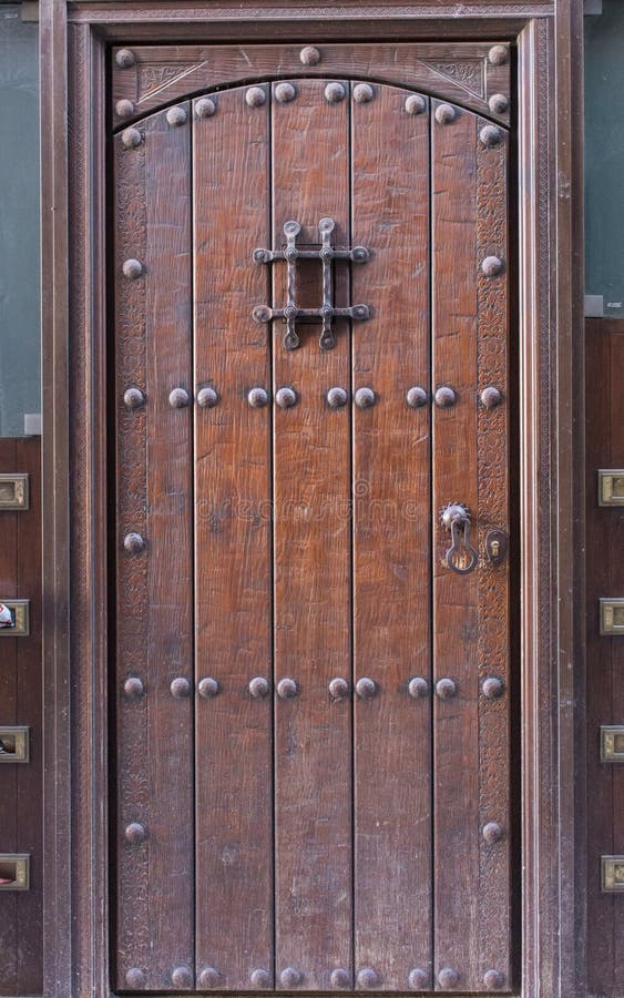 Old wooden door with metal lock. Vintage brown door. Closed doorway of old house. Entrance to antique house. royalty free stock photos