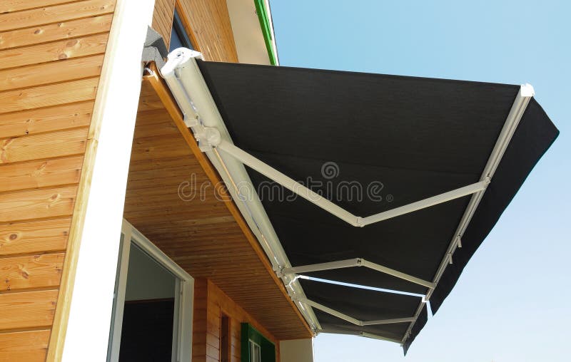 Outdoor high quality automatic sliding canopy retractable roof system, patio awning for sunshade of a modern wooden house. Image stock photo