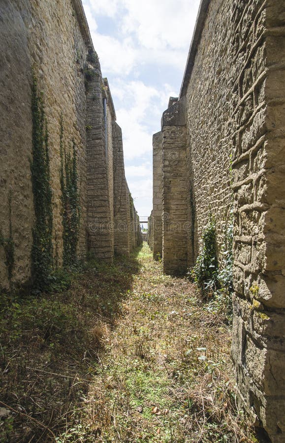 Passage between antique stone walls stock photo