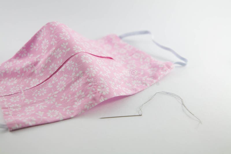 Pink DIY Do it yourself face mask with needle and thread stock photography
