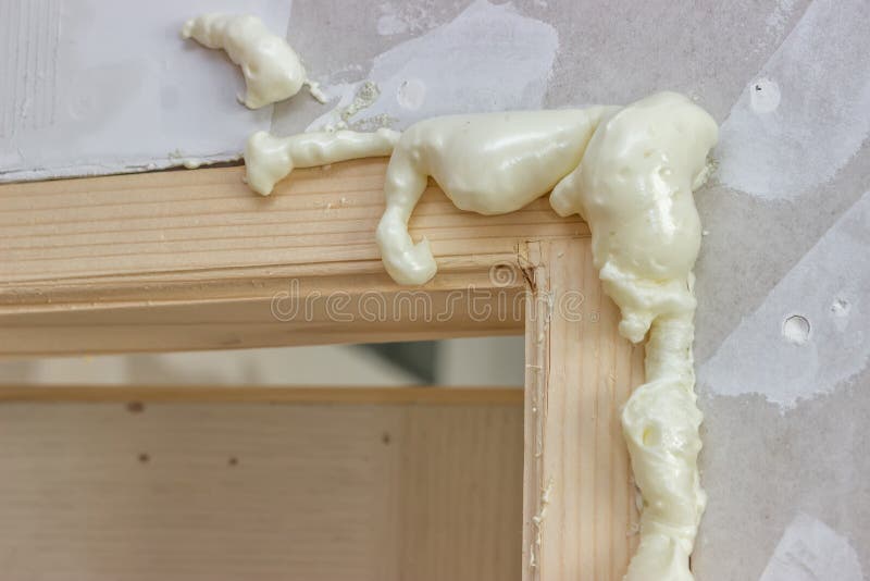 Polyurethane foam around the door frame stock images