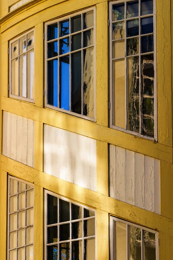 Reflections in the windows in an old wooden house stock photos