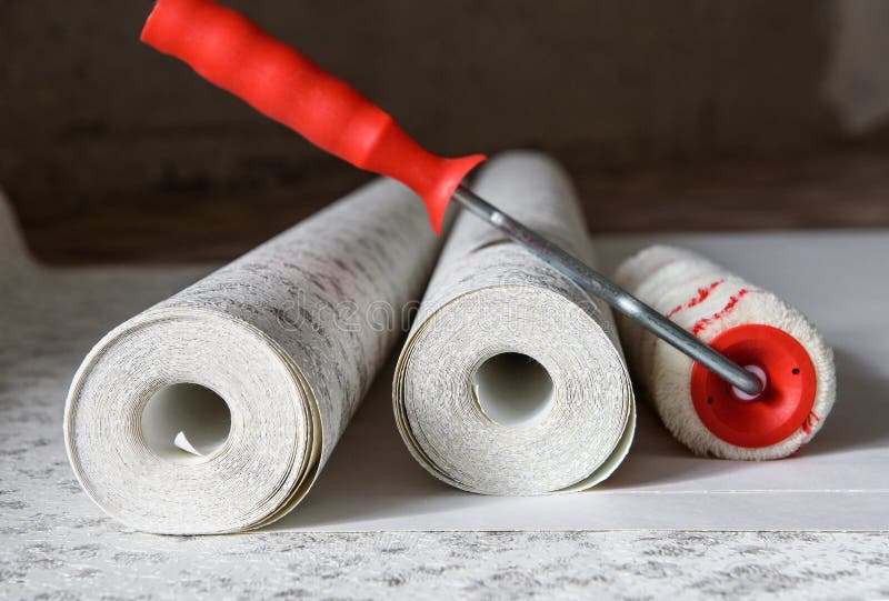 Rolls of wallpaper and roller. Preparation for repair in the apartment royalty free stock image