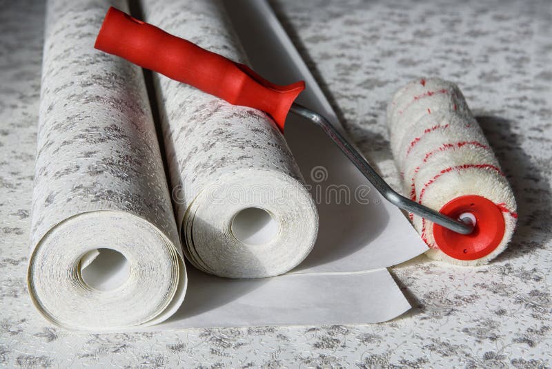 Rolls of wallpaper and roller. Preparation for repair in the apartment royalty free stock photography