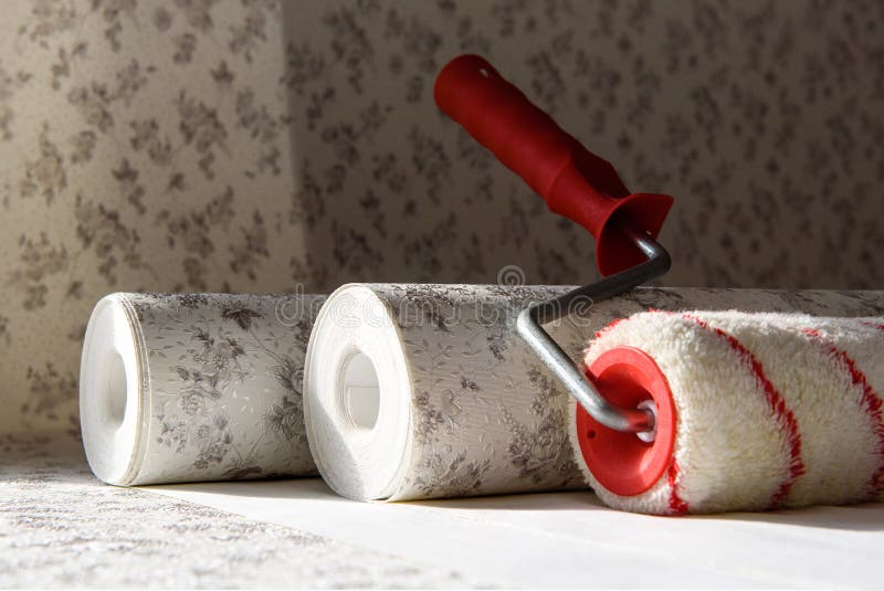 Rolls of wallpaper and roller. Preparation for repair in the apartment royalty free stock photo