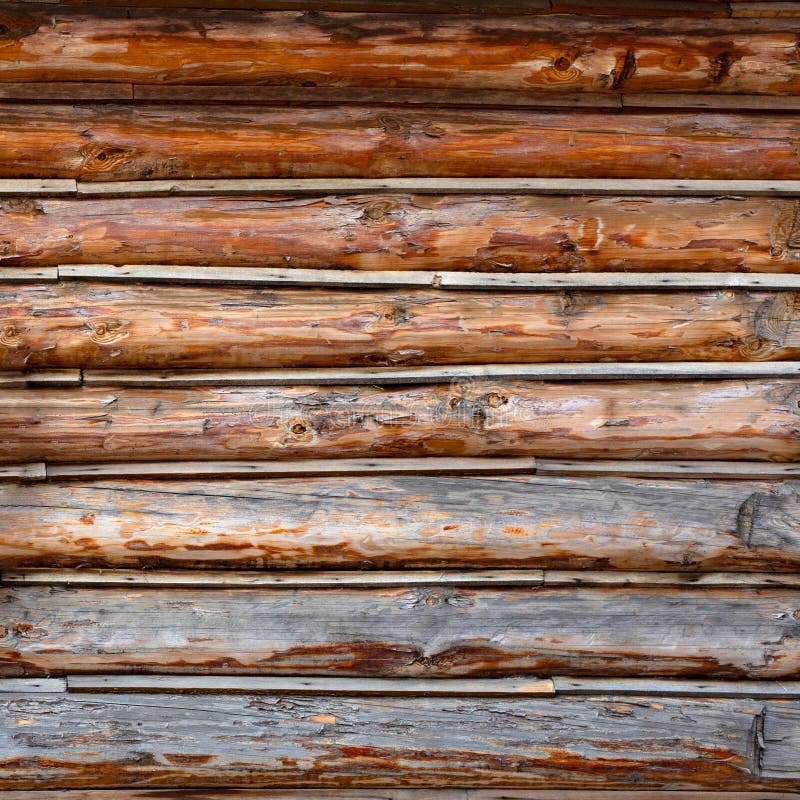 Roundish Rustic Log Wall Horizontal Timber Background. Natural texture part facade of a log wall of cabin or house. Roundish Rustic Log Wall Horizontal Timber royalty free stock photos