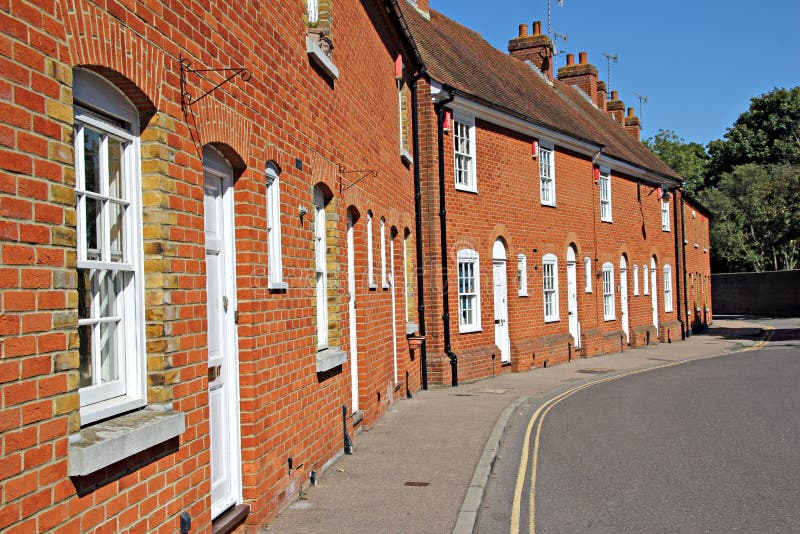 Row of red brick kent cottages. Photo of a row of red brick cottages in a quiet street in the city of canterbury kent england royalty free stock photo