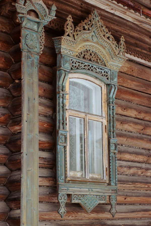Russian traditional wooden house in the village, windows with carved platbands stock images