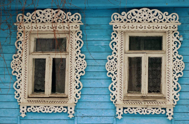 Russian traditional wooden house in the village, windows with carved platbands stock image