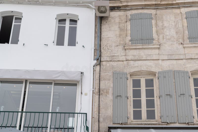 Rustic French building facade white wall and stone facades. A Rustic French building facade white wall and stone facades royalty free stock photo