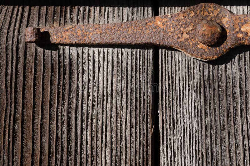Rusty metal fastening on large wooden boards stock photos