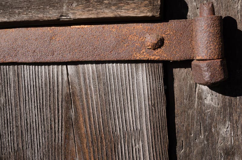 Rusty metal fastening on thick wooden boards royalty free stock photography