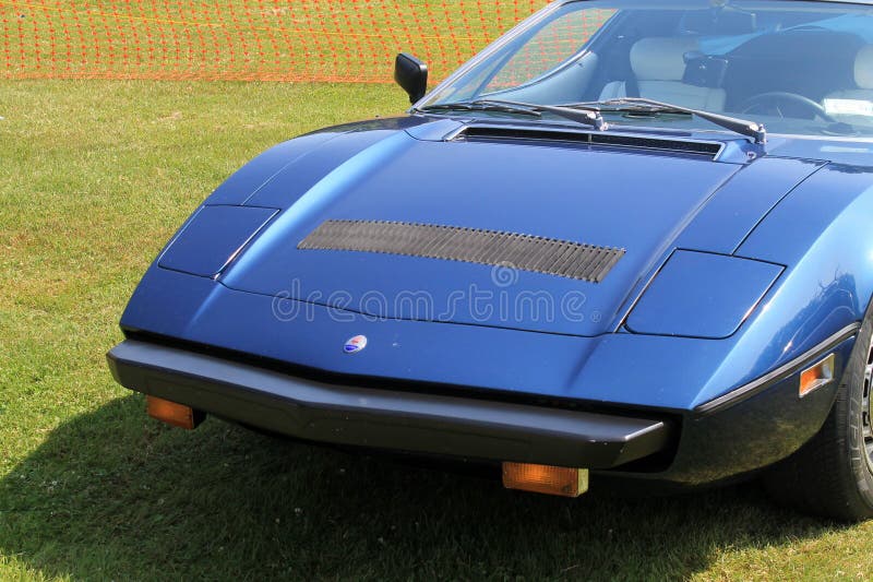1970s Maserati supercar. Close up view of sloping pony snout-type front showing concealed popup headlamps. classic 70s Maserati Bora supercar blue exterior stock images