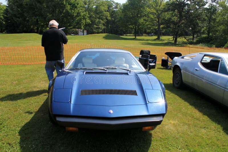 1970s Maserati supercar. Close up view of sloping pony snout-type front showing concealed popup headlamps. classic 70s Maserati Bora supercar blue exterior royalty free stock image