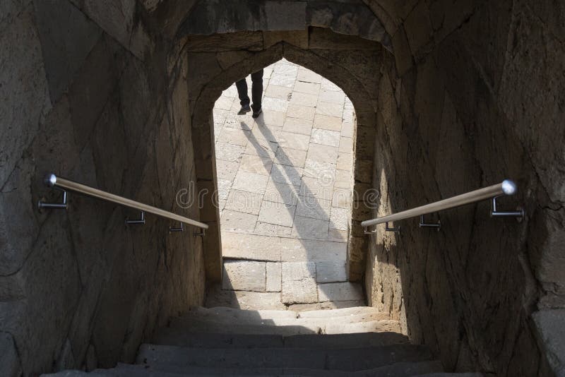 Shadow in the arch doorway,stairs down the entrance through the arch, steps stock photography