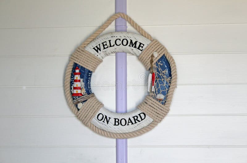 Ships Safety Ring. This photo shows a ships safety ring hanging on a wooden wall with the words 