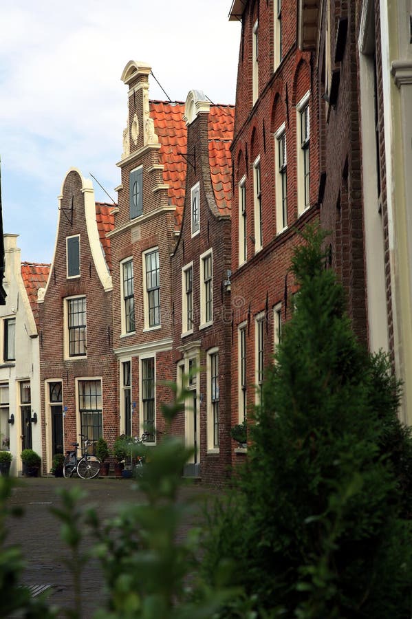Sloping houses in Blokzijl, Netherlands. Narrow street with typical, small, Dutch sloping houses, Blokzijl Netherlands stock photo
