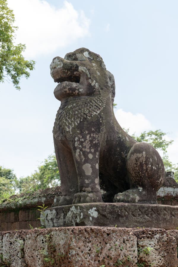 Stone lion on plinth guards East Mebon royalty free stock photos