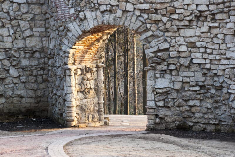 Stone wall with an arch. Old stone wall with an arch royalty free stock image