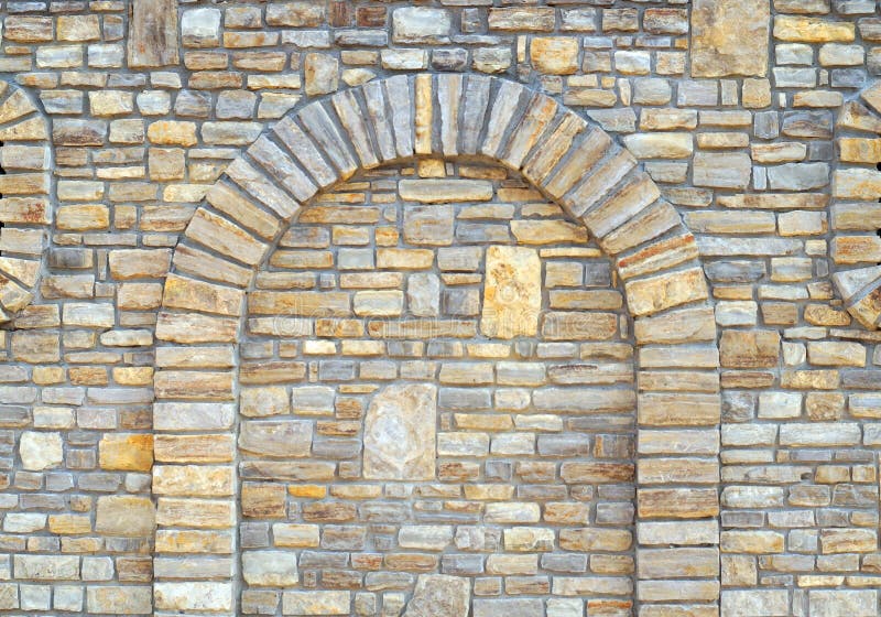 Stone wall background with arch. Walled-up archway in a stone wall background royalty free stock images