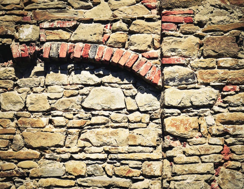 Stone wall with brick arch. Abstract background or texture stone wall with brick arch royalty free stock image