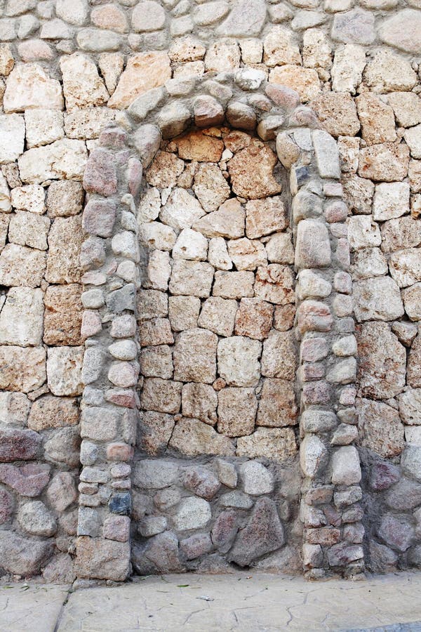 Stone wall with corbel arch. Stone wall from cobble-stones with corbel arch royalty free stock image