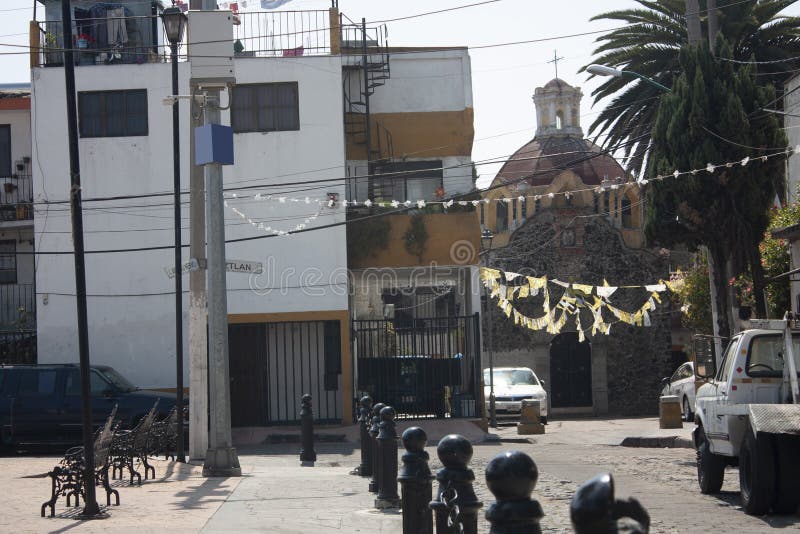 Live streets of Mexico City preserving the old custom of two-color paint on the facades. Streets of Mexico City with the traditional two-color facades that royalty free stock photo