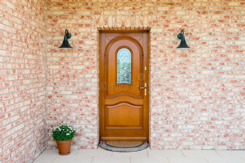 Stylish wooden front - entrance door in a detached house - embed royalty free stock images