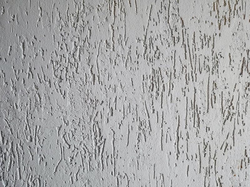 Texture of a fragment of a wall of a modern structure of white color. Harshness in the style of bark beetle.A background for stock photography