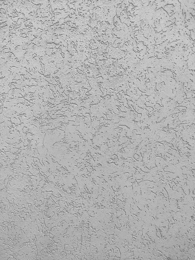 Texture of the grey plaster bark beetle on the wall. Seamless texture. The texture of the plaster is bark beetle on the wall. Seamless grey texture stock image