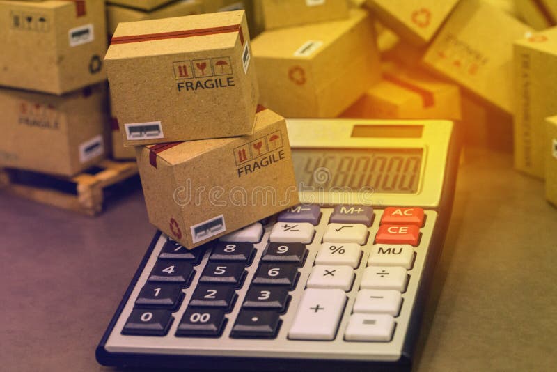Transportation business concept : small papers boxes and calculator. Idea of marketing planning and shipping costs, Control. Financial budget and service charge royalty free stock photos