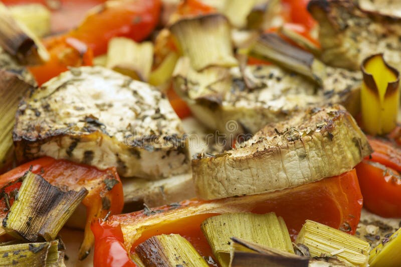 Vegetables mix baked in the oven with aubergine, red bell pepper, leek, basil and olive oil. stock photography