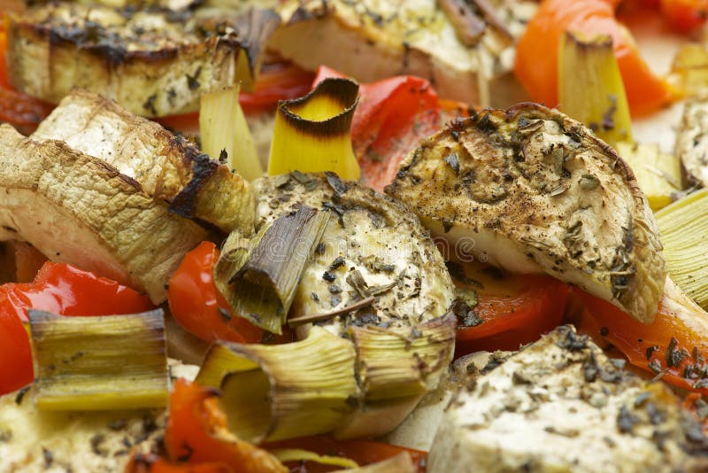 Vegetables mix baked in the oven with aubergine, red bell pepper, leek, basil and olive oil. royalty free stock photo