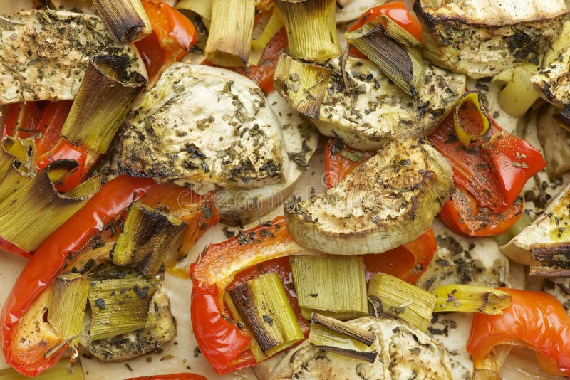 Vegetables mix baked in the oven with aubergine, red bell pepper, leek, basil and olive oil. stock image