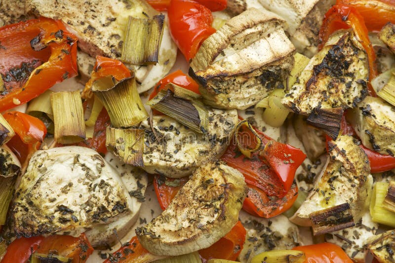 Vegetables mix baked in the oven with aubergine, red bell pepper, leek, basil and olive oil. stock photography