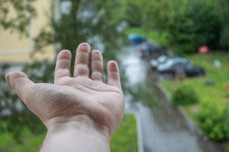 View of the hand from the window of the house during the rain stock photos